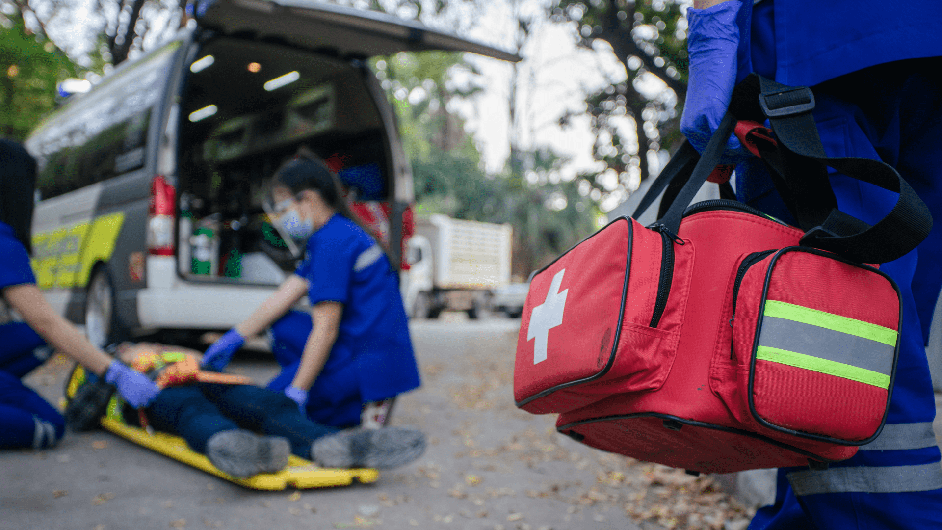 Emergency Responders Using Trauma First Aid Kit at Accident Scene